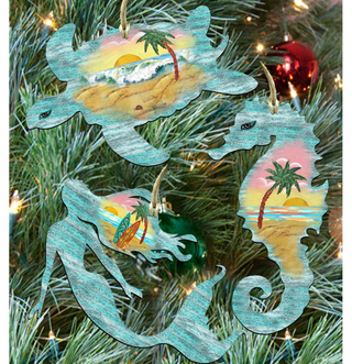a collection of three ornaments hanging on a Christmas tree, each depicting a different tropical scene.