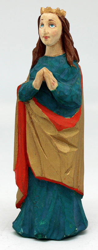 A figurine of a woman wearing a blue and gold dress, with a crown on her head, standing against a plain background.