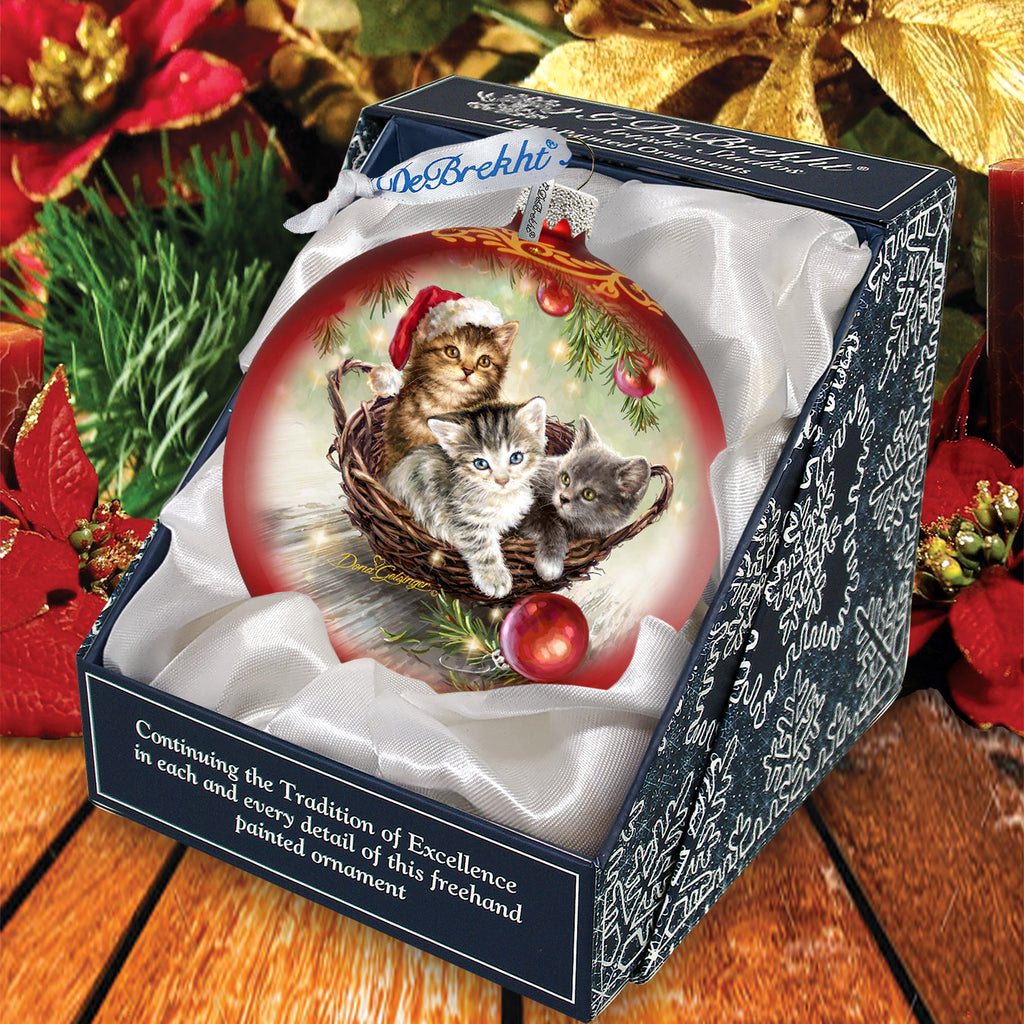 a christmas ornament with two kittens in a basket