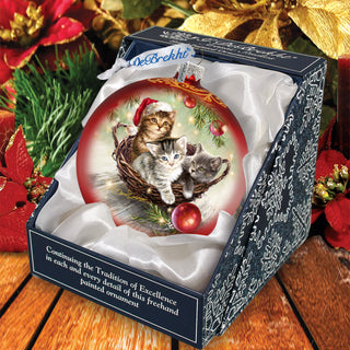 a christmas ornament with two kittens in a basket