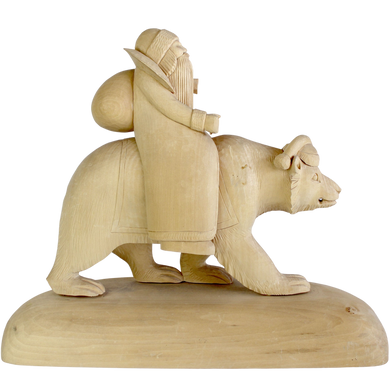 A wooden sculpture depicting a bearded figure riding a bear.