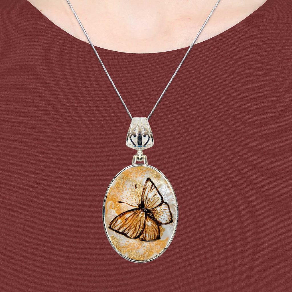 A silver necklace with a circular pendant featuring a butterfly design.