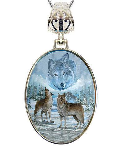 A pendant with a painting of two wolves in a snowy forest, with a large wolf in the background.