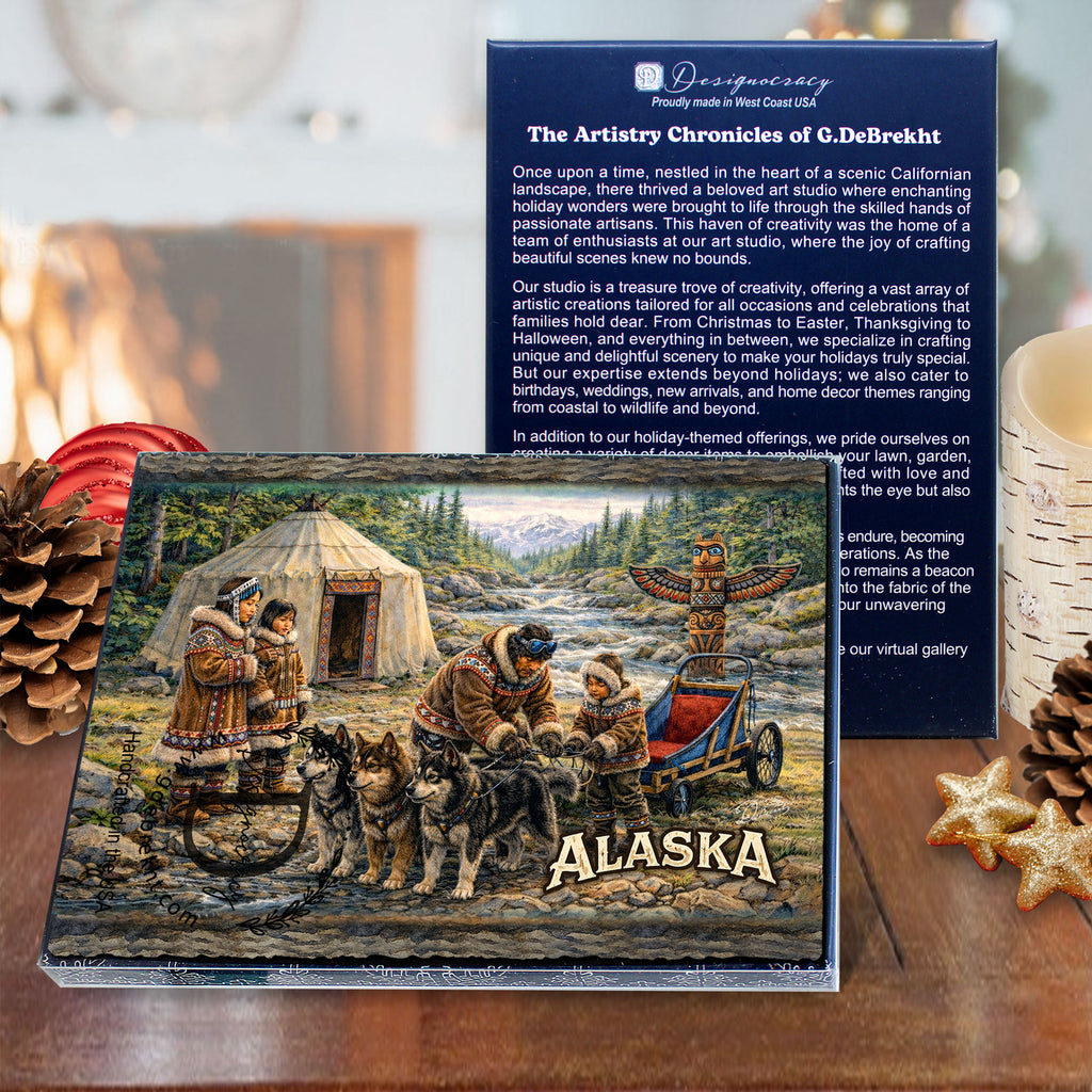 a wooden table with a framed painting of a group of people in traditional clothing, a pine cone, and some star-shaped cookies.