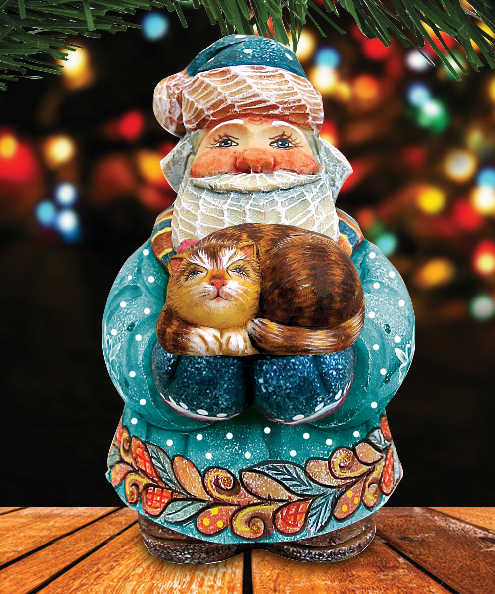 A colorful ceramic Santa Claus figurine holding a cat, set against a blurred background of colorful lights.