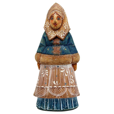 A wooden figurine depicting a woman wearing a blue dress with a white floral pattern and a headdress.