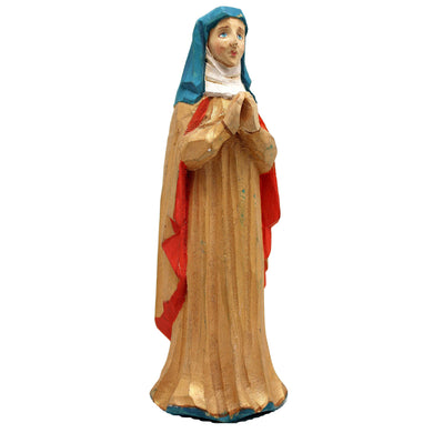 A wooden statue of a woman wearing a red and gold robe and a blue headscarf, standing in a praying position.
