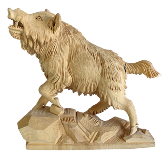 A wooden sculpture of a fierce-looking animal, possibly a bear or a wolf, standing on a rock.