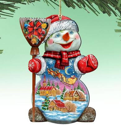 A colorful snowman ornament with a village scene inside, featuring a snowman, houses, trees, and a sleigh in the background.