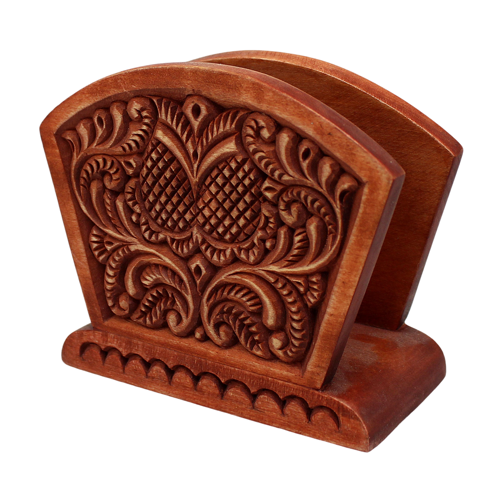 A wooden napkin holder with an intricate carved design on the back.