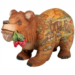 A wooden sculpture of a bear with a painted background depicting various animals and elements of nature.