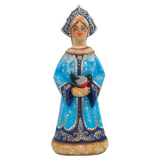 A figurine of a woman wearing a blue dress with gold accents and a blue headdress, holding a bird in her hands.