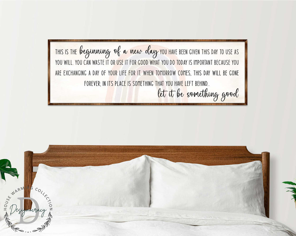 a wooden headboard with a framed inspirational quote above it, which reads: