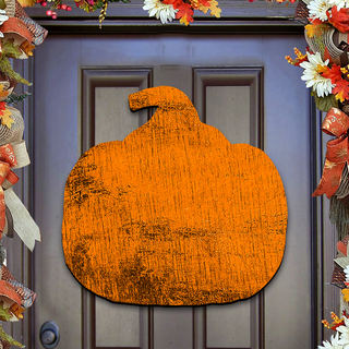 a large orange pumpkin-shaped sign hanging on a door.