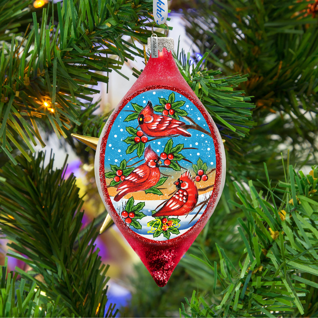 a red ornament hanging from a christmas tree
