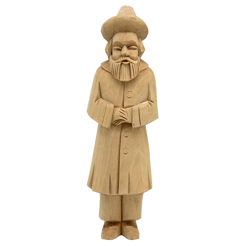 A wooden statue of a bearded man wearing a hat and coat, standing upright and facing forward.