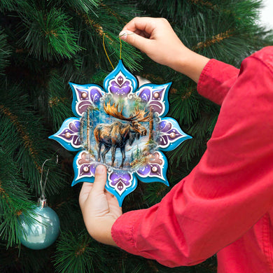 a person holding a christmas ornament in front of a christmas tree