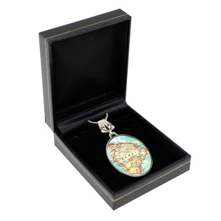 a black jewelry box containing a decorative oval-shaped charm with a map of the world on it.