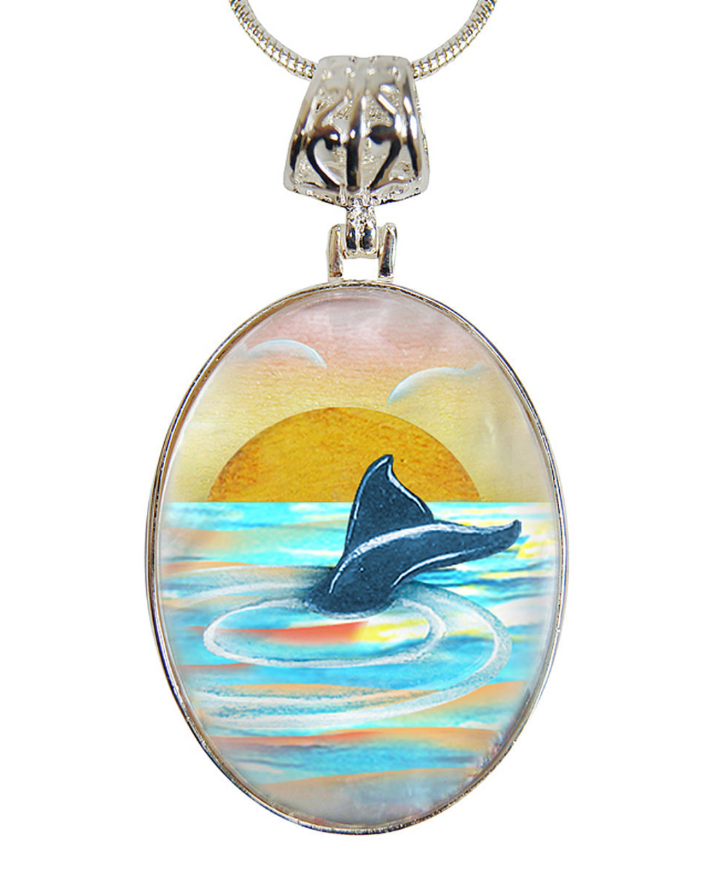 A pendant necklace with a circular design featuring a painting of a dolphin swimming in the ocean at sunset.