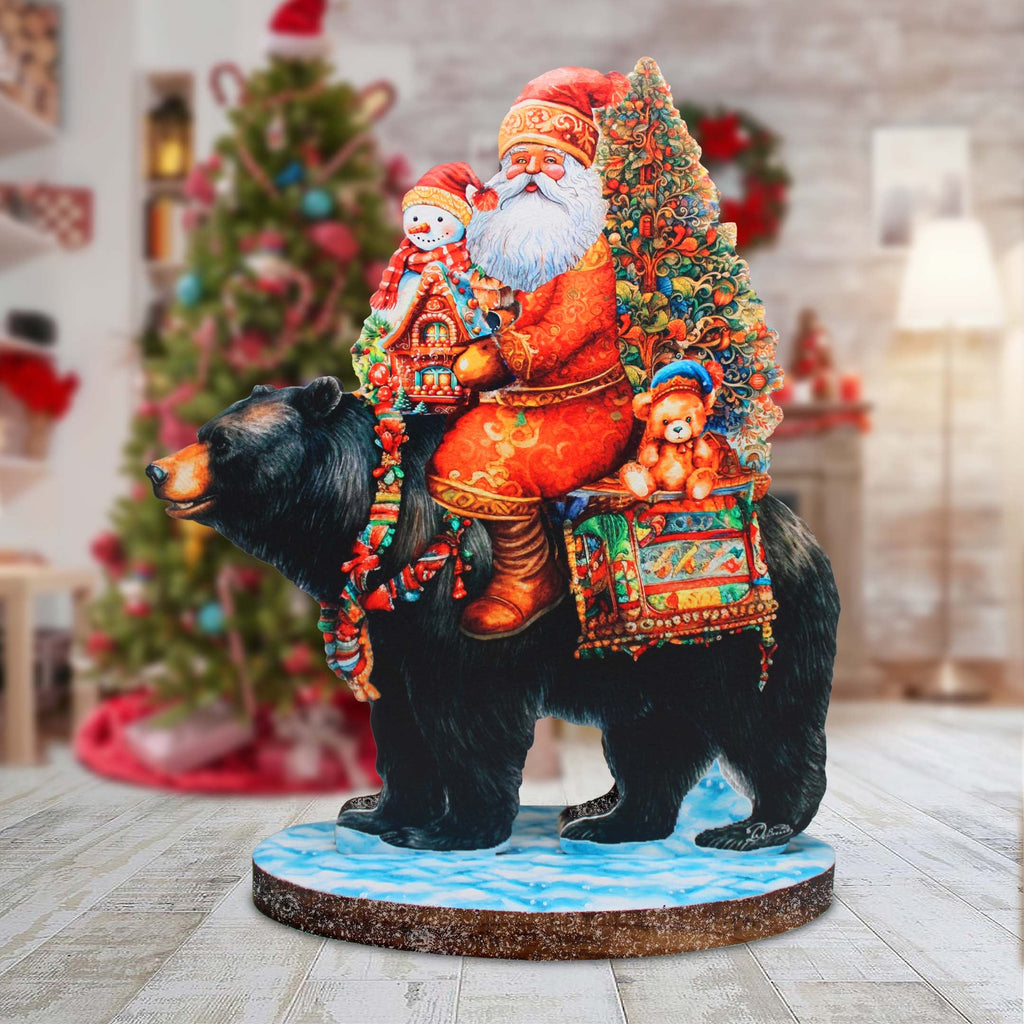 a statue of santa riding a bear with a christmas tree in the background