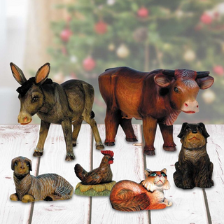 a collection of six wooden figurines depicting various animals, including a donkey, cow, chicken, dog, cat, and rooster, arranged on a wooden surface.