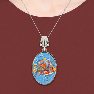A necklace with a pendant featuring a colorful, circular design of fish and other aquatic elements.