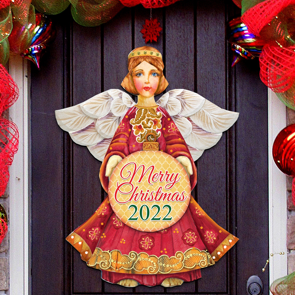A Christmas-themed door decoration featuring a painted angel holding a