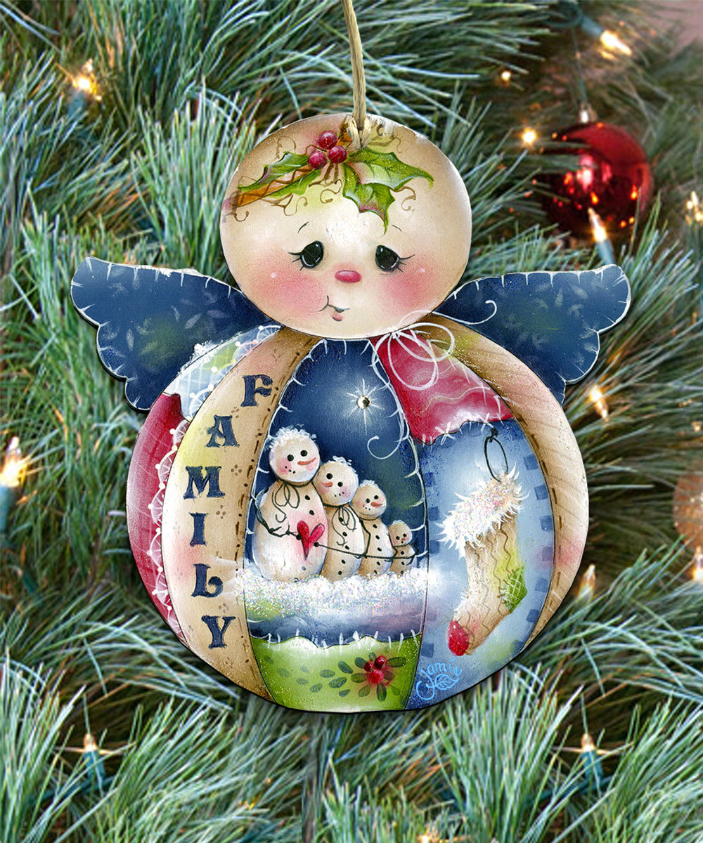 A colorful ornament with a family theme, featuring a snowman, snowmen, and a holly leaf, hanging on a Christmas tree.