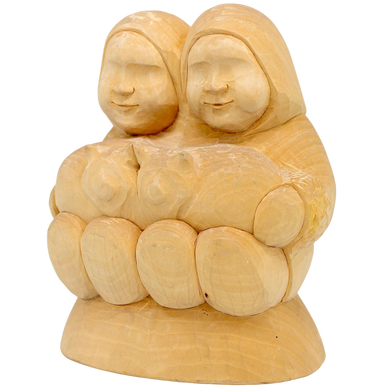 A wooden sculpture depicting two women holding a cat.