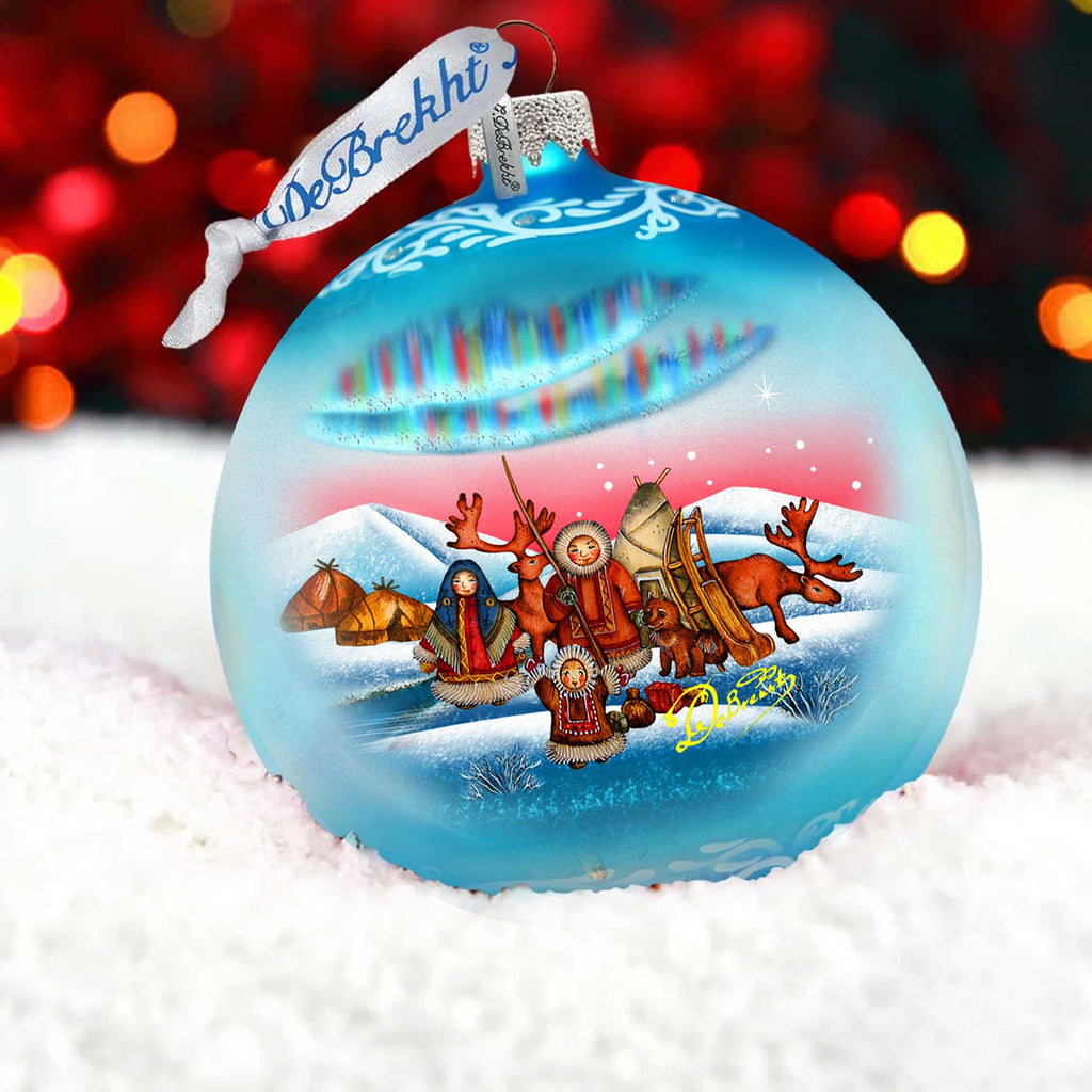 a glass ornament with a christmas scene on it
