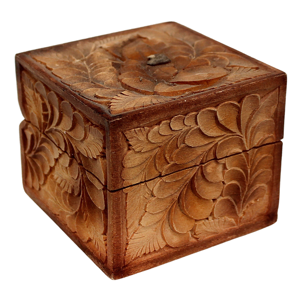 A wooden box with intricate carved designs, including leaves and flowers, on its surface.