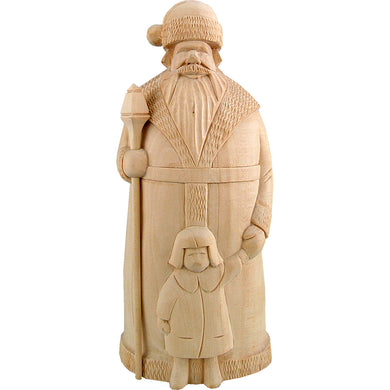 A wooden carving of Santa Claus holding a young child, likely a baby, in his arms.
