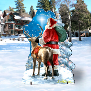 A cardboard cutout of Santa Claus and a reindeer standing in the snow, with a bright star in the sky behind them.