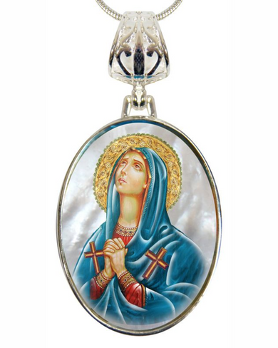 A pendant featuring a religious icon of a woman in a blue robe and a halo, with a cross on her left hand.