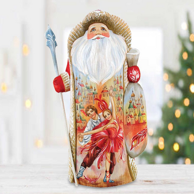 A figurine of Santa Claus holding a dancing couple, with a background of a snowy village and Christmas lights.