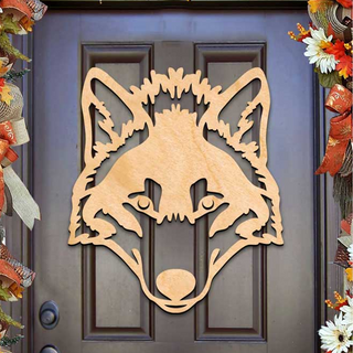 a wooden cutout of a wolf's head on a dark wooden door, surrounded by a decorative border of autumn leaves and flowers.