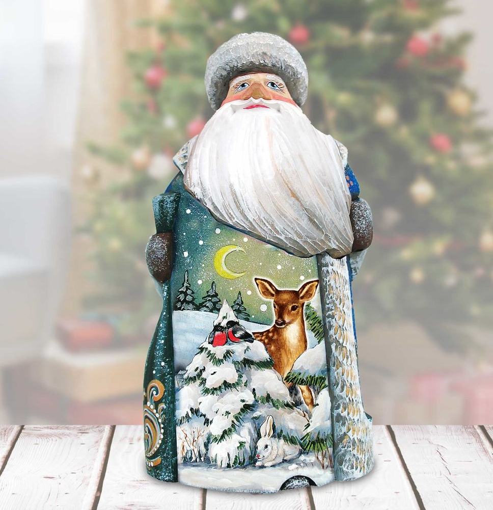 A wooden Santa Claus figurine with a white beard and hat, standing in front of a Christmas tree.