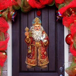 a door with a wreath and a statue of santa