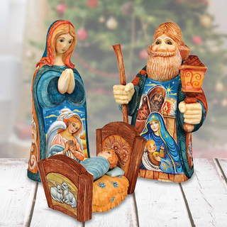 a nativity scene with three wooden figurines representing the baby Jesus, Mary, and Joseph, each holding a different object. The figurines are set against a blurred background, likely a Christmas tree, creating a festive and religious atmosphere.