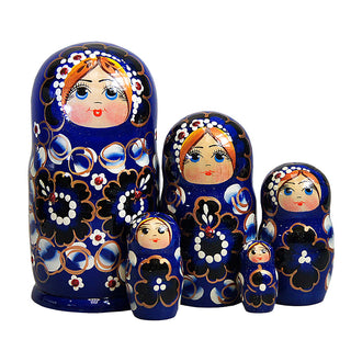A set of six blue nesting dolls with intricate floral designs and painted faces, arranged in a row.