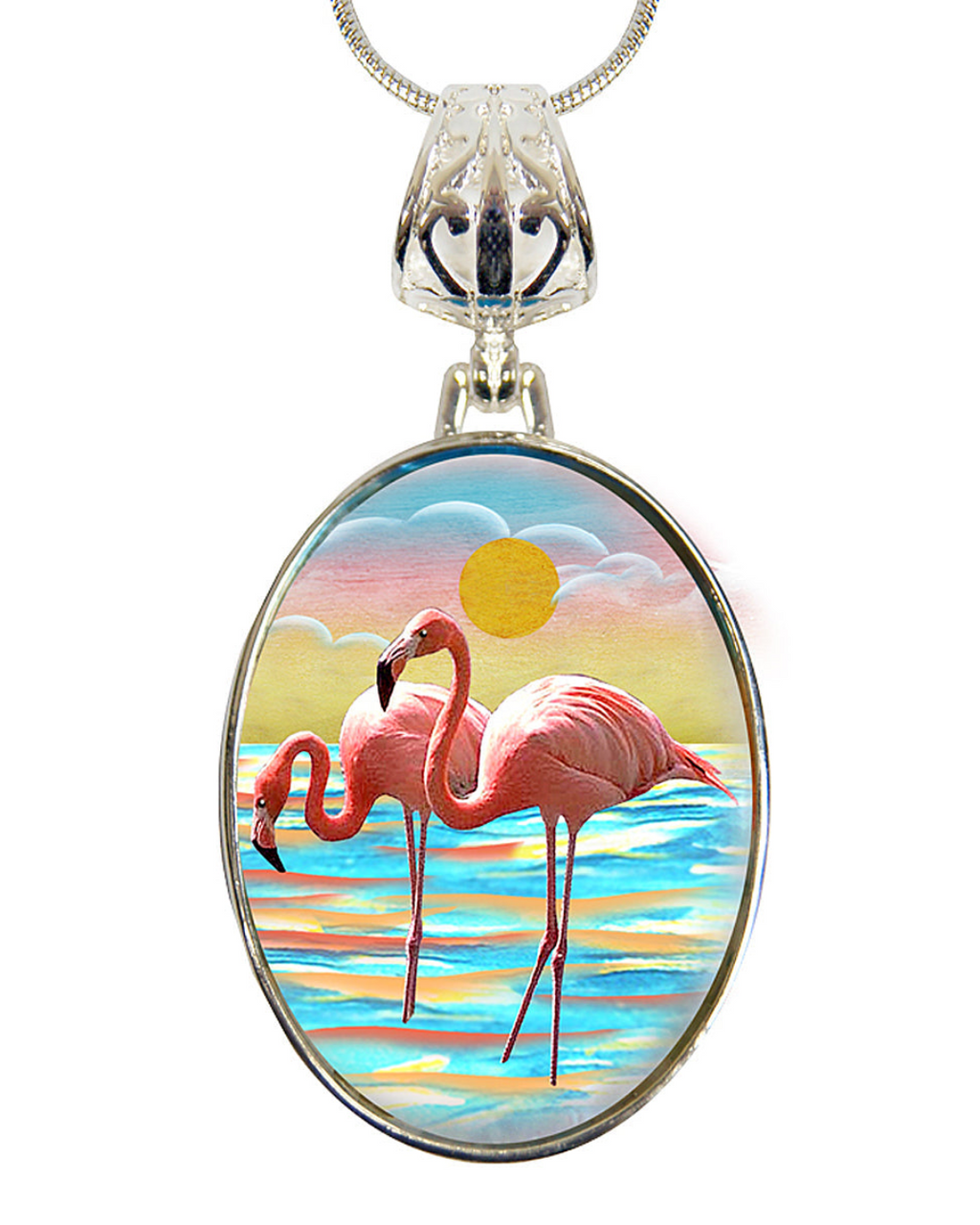 A pendant necklace with a circular design featuring two pink flamingos standing on a beach at sunset.