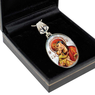 a pendant with a religious icon, such as a depiction of the Virgin Mary, displayed in a black box.