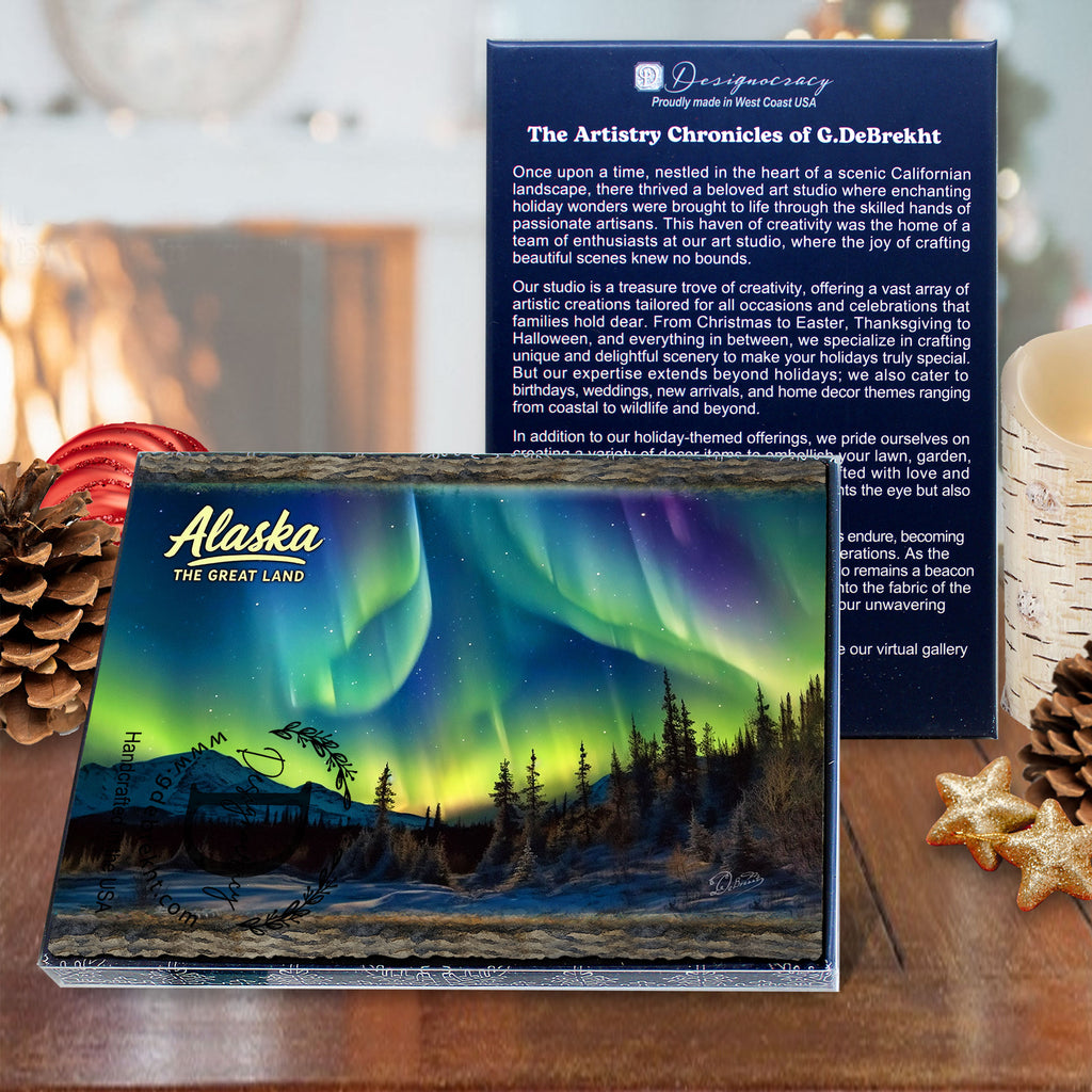 a large Alaska magnet with a stunning image of the Northern Lights, accompanied by a smaller card with text describing the magnet. The magnets are placed on a table with pine cones and star anise, creating a festive and holiday-themed display.