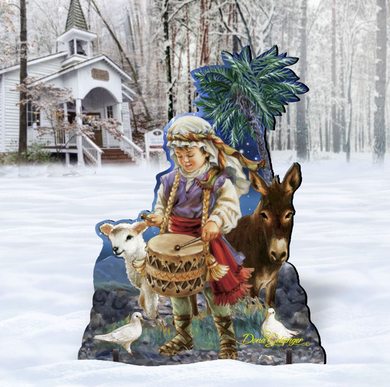 A wooden cutout of a child playing a drum, surrounded by a donkey and two birds, with a snowy landscape in the background.