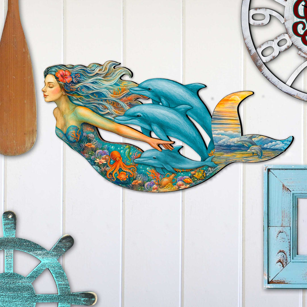 Handcrafted mermaid wall art with dolphins, coral reef, and ocean sunset, created by GDebrekht Artistic Studio. Features vibrant underwater details and flowing design, perfect for coastal wall decor, beach house accents, or ocean-themed gifts. Made in the USA, ideal for indoor display above couches or entryways. A unique piece of coastal holiday decor.