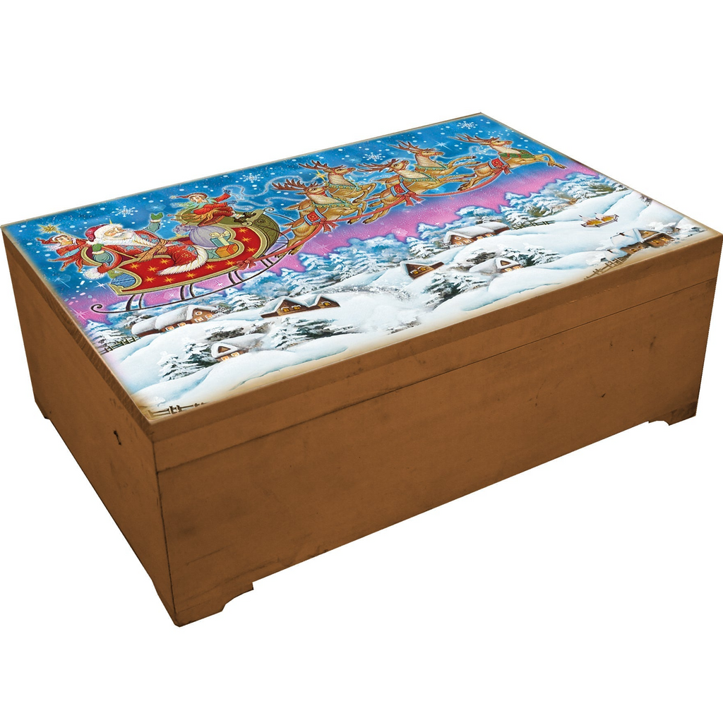 A wooden box with a painted illustration of Santa Claus and reindeer on a sleigh, set against a snowy winter landscape.