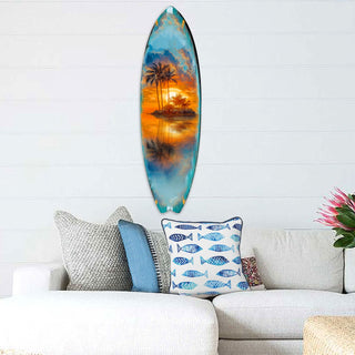 Handcrafted Tropical Sunset Surfboard Wall Art by G. DeBrekht, featuring a serene island scene with palm trees and a golden sunset reflected on tranquil waters. Perfect coastal wall decor for beach houses, surf-themed spaces, and nautical interiors. UV-coated for indoor & outdoor display.