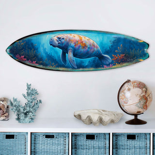 Handcrafted Manatee Surfboard Wall Art by G. DeBrekht, featuring a gentle manatee swimming through a vibrant underwater scene with coral and marine life. Perfect coastal wall decor for beach houses, ocean lovers, and nautical interiors. UV-coated for indoor & outdoor display.
