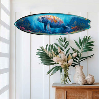 Handcrafted Manatee Surfboard Wall Art by G. DeBrekht, featuring a gentle manatee swimming through a vibrant underwater scene with coral and marine life. Perfect coastal wall decor for beach houses, ocean lovers, and nautical interiors. UV-coated for indoor & outdoor display.