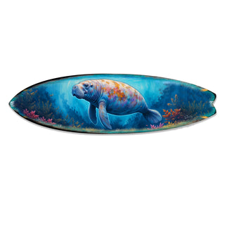 Handcrafted Manatee Surfboard Wall Art by G. DeBrekht, featuring a gentle manatee swimming through a vibrant underwater scene with coral and marine life. Perfect coastal wall decor for beach houses, ocean lovers, and nautical interiors. UV-coated for indoor & outdoor display.